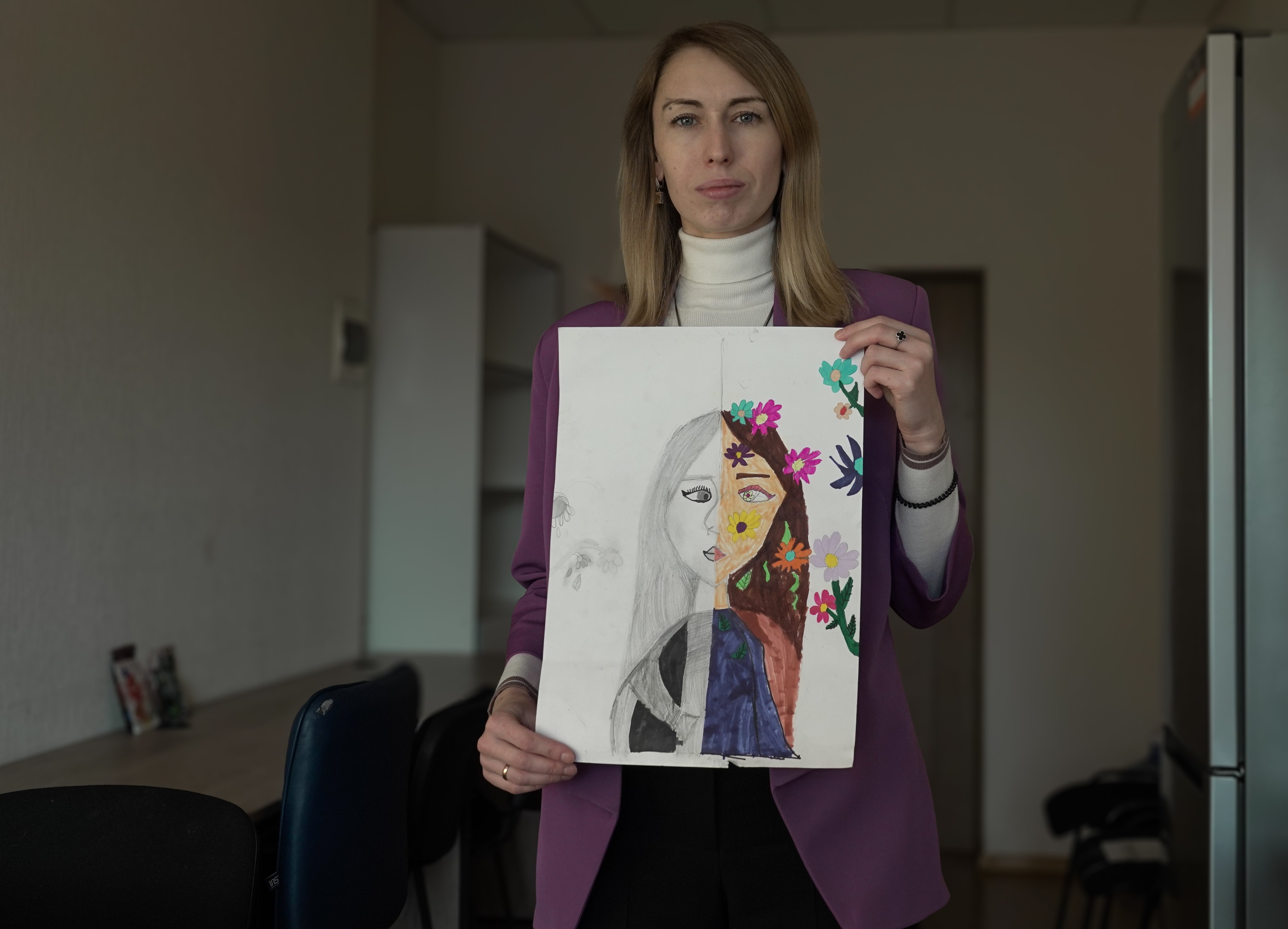 Varvara showing a self portrait made by her daughter Varvara 