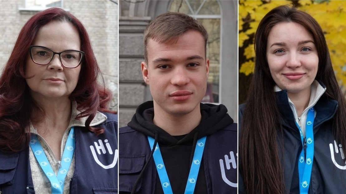 Three side-by-side portraits show members of the humanitarian organization HI. On the left, a woman with red hair and glasses wears a blue vest with the HI logo and a badge around her neck. In the center, a young man with short hair wears a black hoodie under his HI vest. On the right, a smiling young woman with long brown hair wears an HI jacket. 